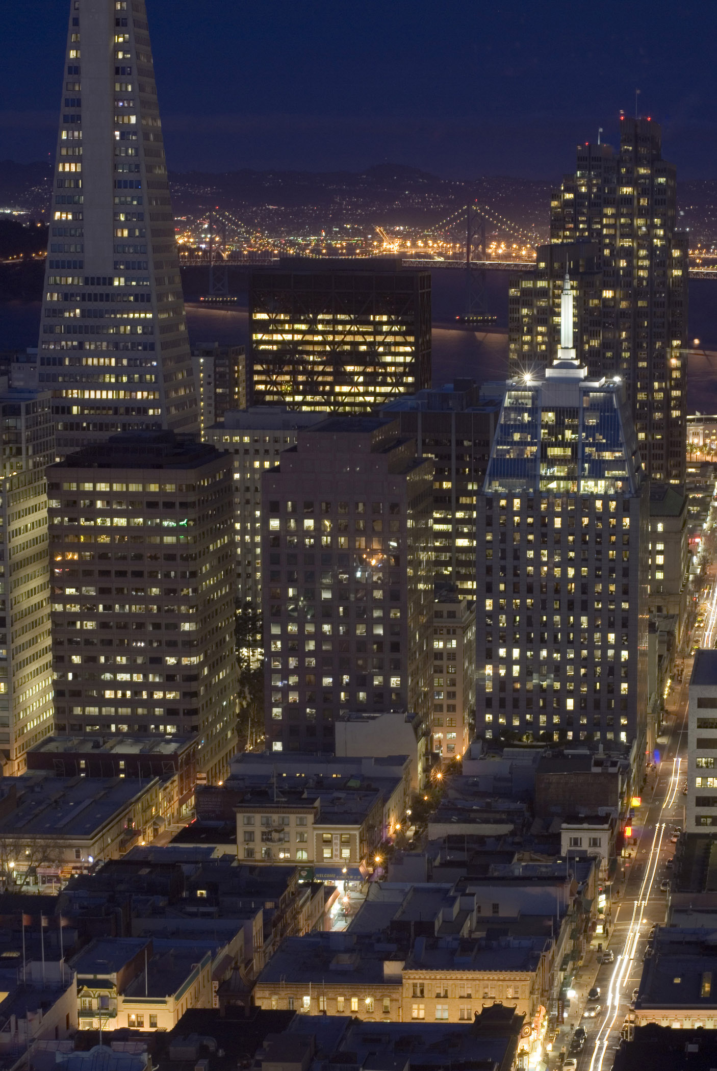 an image of San Francisco at night with illuminated windows in the skyscrapers and buildings of the CBD