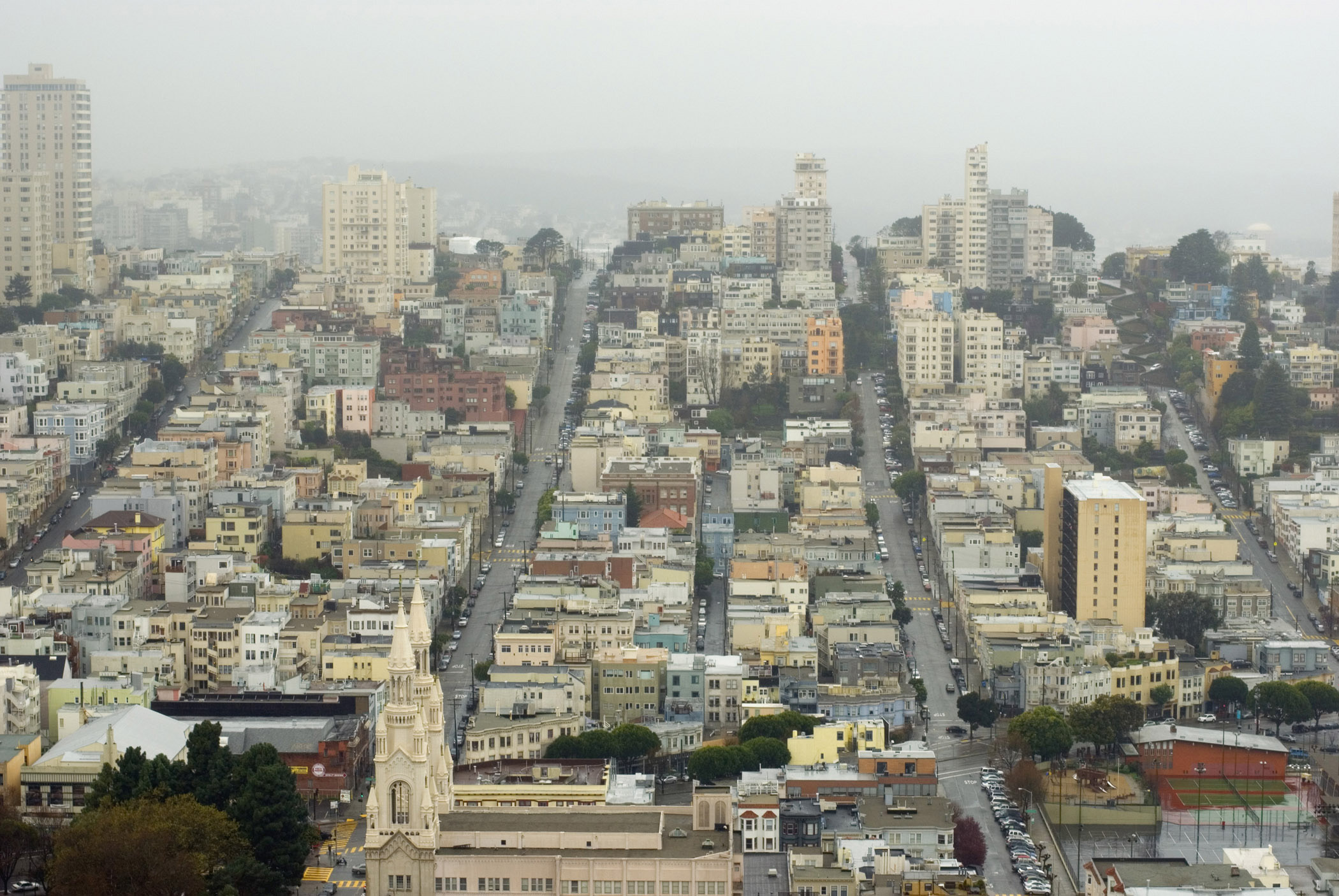 an image of San Francisco City Streets and Assorted Buildings in Aerial View. Captured on a Foggy Day.