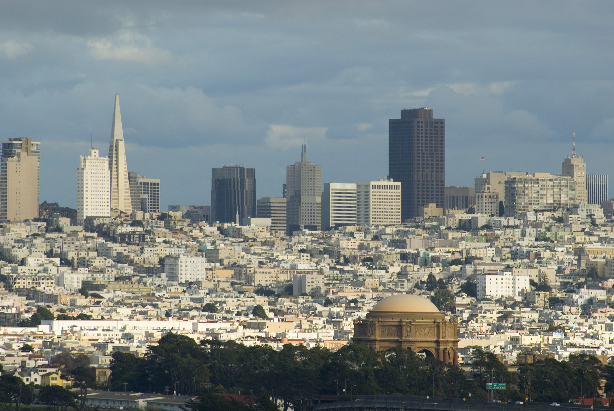an image of Striking Extensive View of San Francisco Skyline. Captured with Various Buildings on Light Blue Gray Sky Above.