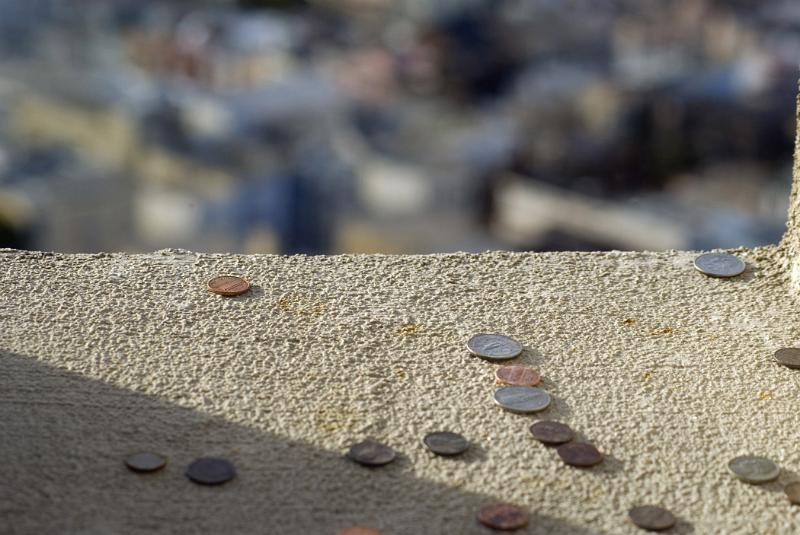 Close up Assorted Coins at Coit Concrete Tower Window in San Francisco.