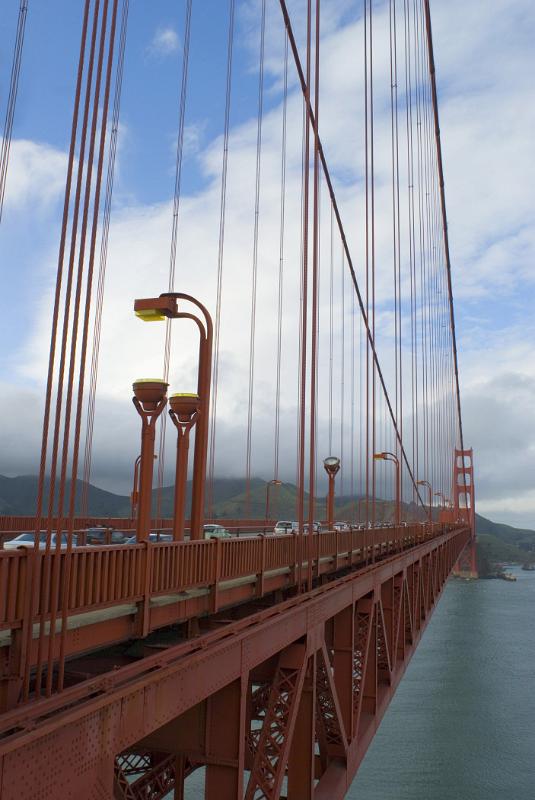 Golden Gate Bridge Metallic Cables Metallic Cables at Iconic Golden Gate Bridge in San Francisco. Captured on Light Blue and White Sky Background.