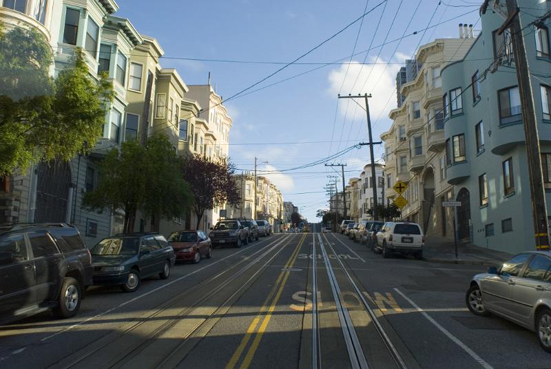 Cable car ride through the streets of San Francisco looking back along the tracks down the street in a residential district