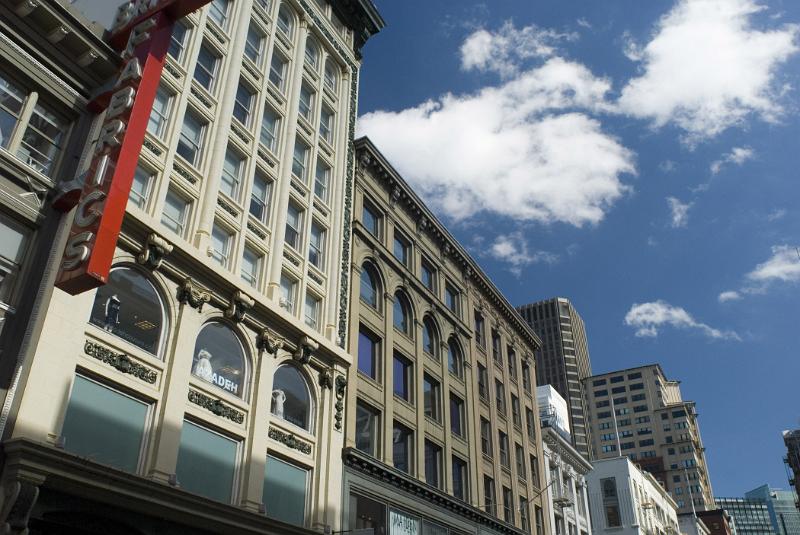 Beautiful Huge Architectural Building Structures in San Francisco. Captured at Low Level Angle. Isolated on Light Blue and White Sky.
