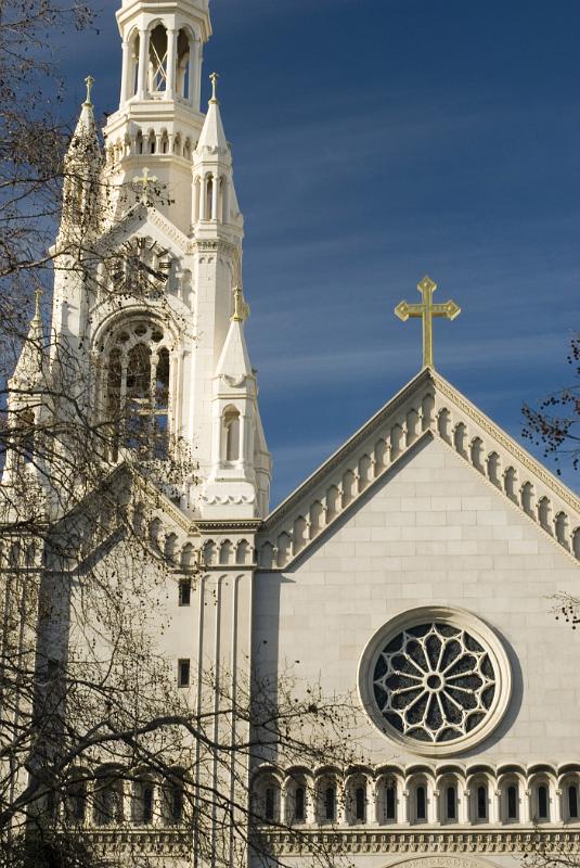 Spire of the Church of Saints Peter and Paul in Washington Square, San Francisco against a sunny blue sky