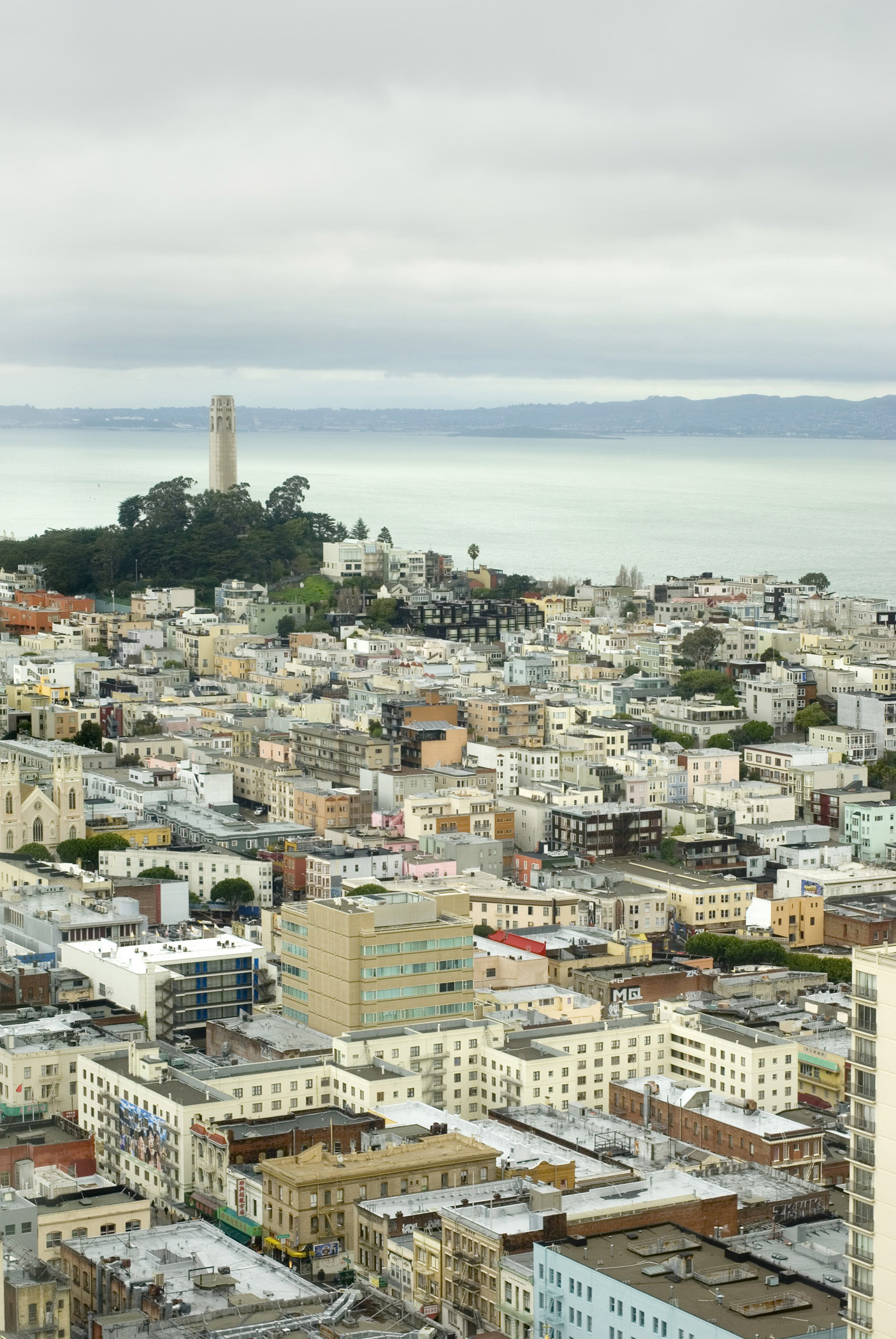 an image of Plenty City Buildings with Coit Tower View From Far Distant in Aerial View.