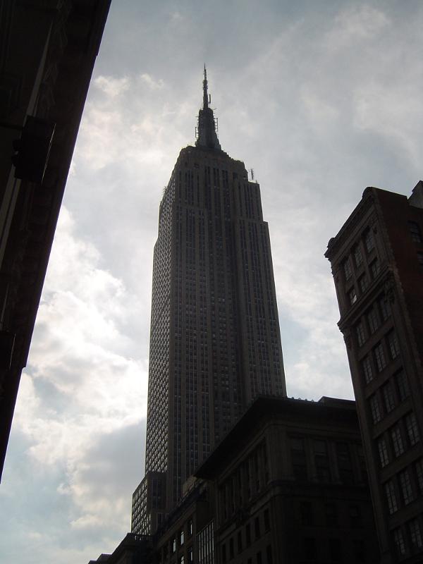 Low angle view looking up of the Empire State Building, Manhattan, New York, silhouetted against a cloudy sky