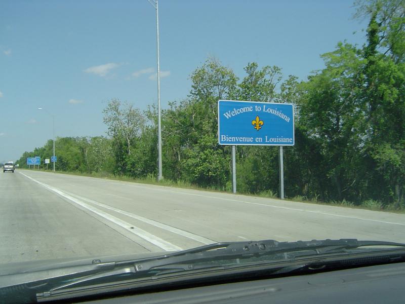Welcome to Louisiana road sign at the edge of a freeway as seen from inside a motor vehicle through the windscreen