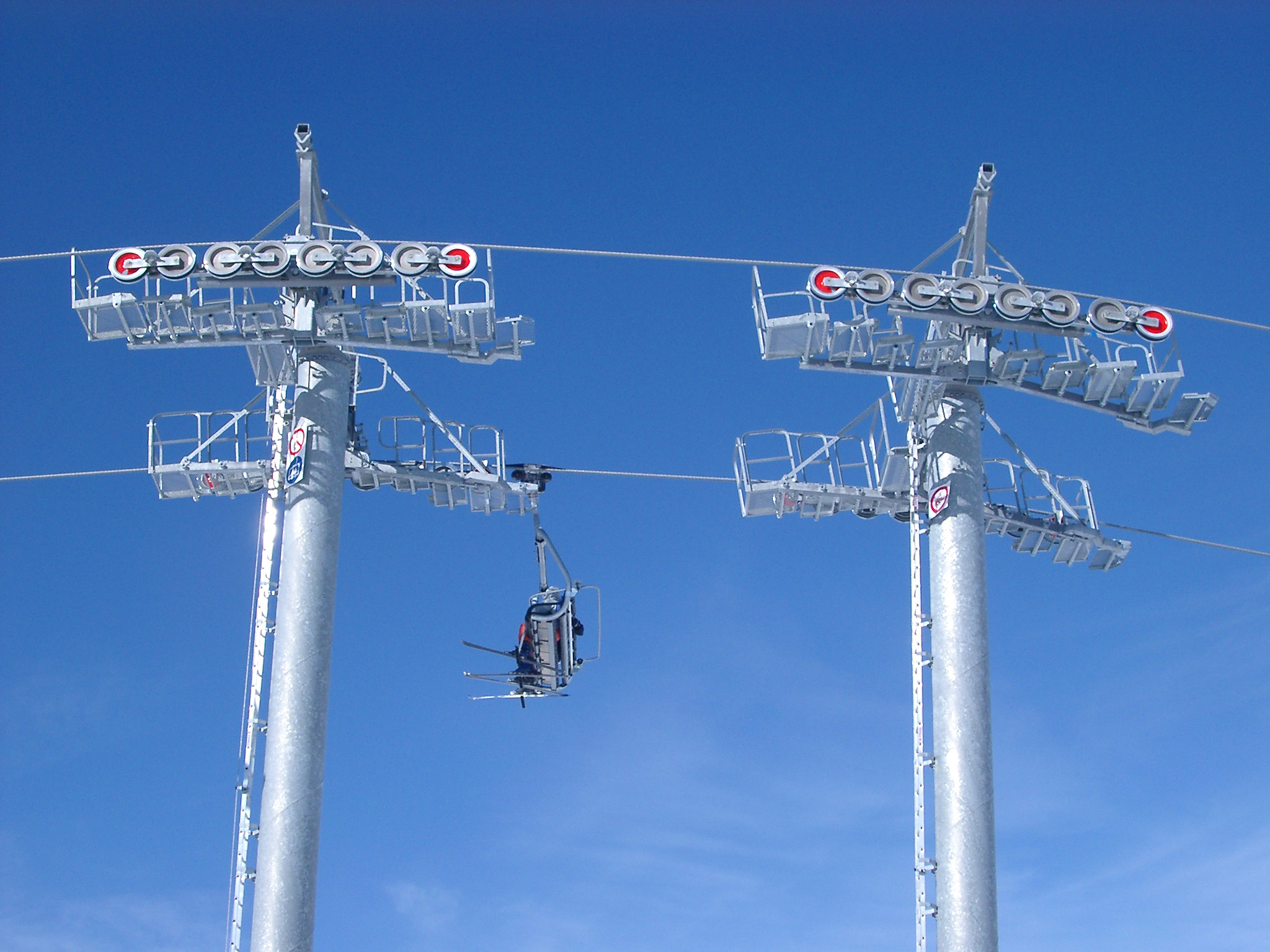 an image of Empty Cable Cars on Light Blue Sky Background.