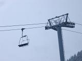Cable car or Alpine chair lift for taking tourists and skiers to the mountain ski slopes with an empty chair suspended close to a pylon or tower