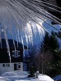 Unique Icicle Forms at House Roof During Winter Holiday Season